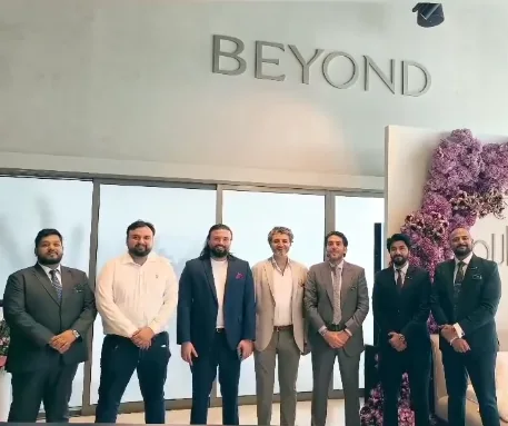 The Throne Properties team standing together in front of the BEYOND sign