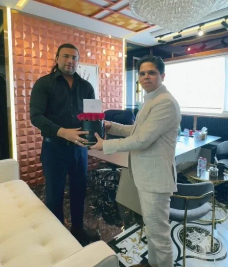 A Throne Properties team member presenting flowers to Ankur Aggarwal, Chairman and Founder of BNW